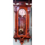 A 19th century Vienna three train wall clock with enamel Roman dial, within corinthian columns.