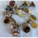 A curb pattern bracelet with 9ct gold padlock, suspending 13 various charms, including: fob, seals,