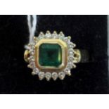 An emerald and diamond cluster ring,