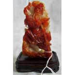 A piece of Oriental carved russet and mutton fat jade, in the form of the rampaging God of War.