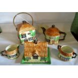 Five pieces of Beswick thatched cottage teawares.