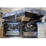 Two vintage black cased manual typewriters.