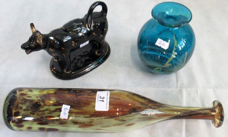 A black glazed 19th century Jackfield cow creamer & cover and two items of Mdina studio glassware.