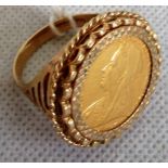 A 1901 gold sovereign in a loose mounted pierced gentleman's dress ring.