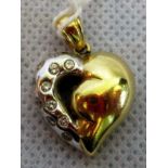 A bi-coloured diamond set heart shaped pendant,