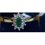 An emerald and diamond cluster ring,