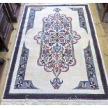 A 20th century Persian rug, woven with a bold central floral medallion,