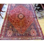 A 20th century Persian rug, woven with central lozenge and latch hook medallion,