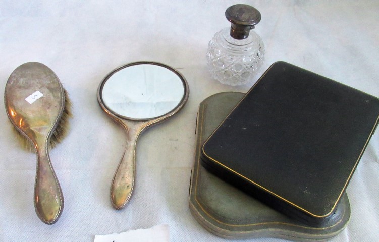 A silver backed hand mirror and brush, a silver mounted scent of spherical form,