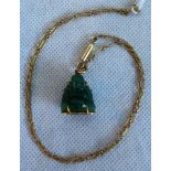 An Oriental carved jade Buddha pendant and associated fetter and free chain.