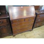 A reproduction mahogany bureau, the crossbanded fall enclosing a fitted interior,