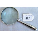 A magnifying glass with hallmarked silver handle.