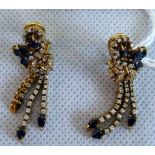A pair of sapphire and diamond pendant earrings of bow form with three diamond set tassels