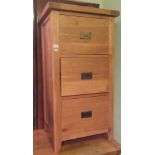 A 20th century light oak three drawer filing cabinet.