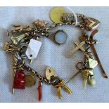 A charm bracelet with padlock clasp, suspending numerous charms, including a chimney sweep,