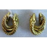 A pair of precious yellow metal twisted hoop earrings.