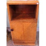 A bur walnut veneered bedside cupboard, with open shelf and door on plinth.