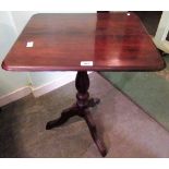 A mahogany tripod table,