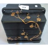 An early 20th century Japanese black lacquer and gilt chinoiserie decorated jewellery box in three