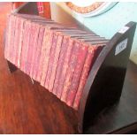 An oak book rack, containing the leather and gilt tooled whole works of Shakespeare.