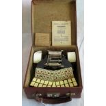 A Stenotype Grandjean mini typewriter in leather case.