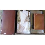 Three vintage fibre suitcases, one containing a collection of miscellaneous table linen.