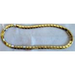A yellow precious metal and diamond necklace of polished rounded rectangular links,