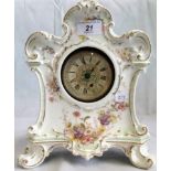 An early 20th century French porcelain bodied mantle clock, decorated with sprays of summer blooms.