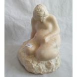 A mid-20th century carved vein ochre marble seated figure Motherhood.