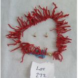 A spiky coral necklace, together with a pair of stud earrings.