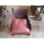 An oak framed and leather studded armchair.