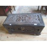 A small 20th century profusely carved Chinese blanket box.