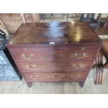 A 19th century mahogany chest of three long drawers, having brushing slide and out-swept feet.