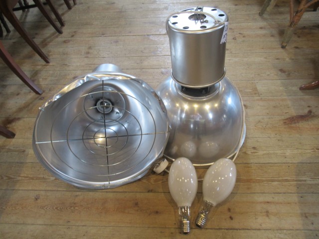 A pair of industrial aluminium lamps.
