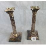 A pair of silver Corinthian column candlesticks, London 1923, 28cm high.