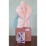 Peter Martin 'Standing Captive'. Stylized bust stone sculpture on a matted square stone plinth.