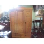 A 19th century Continental pine three door wardrobe.