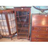 A mahogany glazed single door china cabinet.