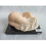 A 20th century carved ochre marble figure of a sleeping nude lady with long flowing hair,