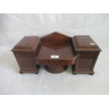 A Victorian mahogany tea caddy in the form of a twin pedestal break-front sideboard.