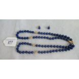 A lapis lazuli set of beads and matching earrings.