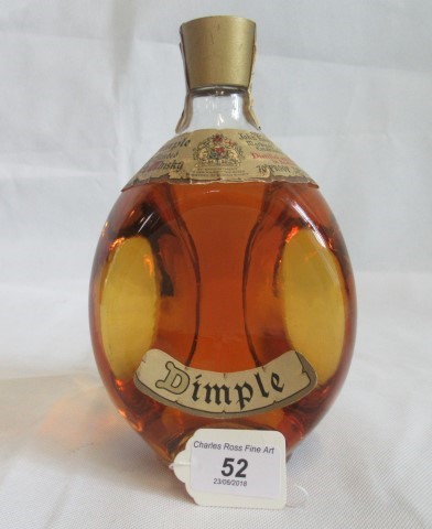 A bottle of Old Blended Dimple Scotch Whisky.