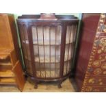An Edwardian mahogany glazed front single door china cabinet, on ball and claw supports.