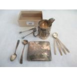 A silver cream jug, silver sugar tongs and silver spoons, various dates and makers,