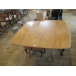 A 1960's G Plan-style drop-leaf dining table.