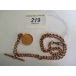 A 9ct curbed pattern watch chain, with an attached mobile mounted half sovereign.