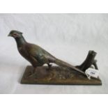 An early 20th century gilt metal match strike in the form of a pheasant on stylized base.