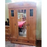 A 19th century Continental pine wardrobe, having central mirrored door,