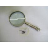 A silver handled magnifying glass.