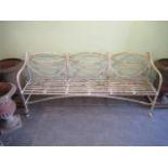 An early 20th century wrought iron painted garden bench, with lattice work design and shaped front.